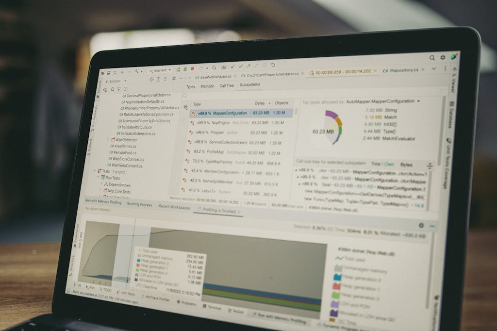 A close-up view of a laptop screen showing a coding and data analysis software interface in an indoor setting.